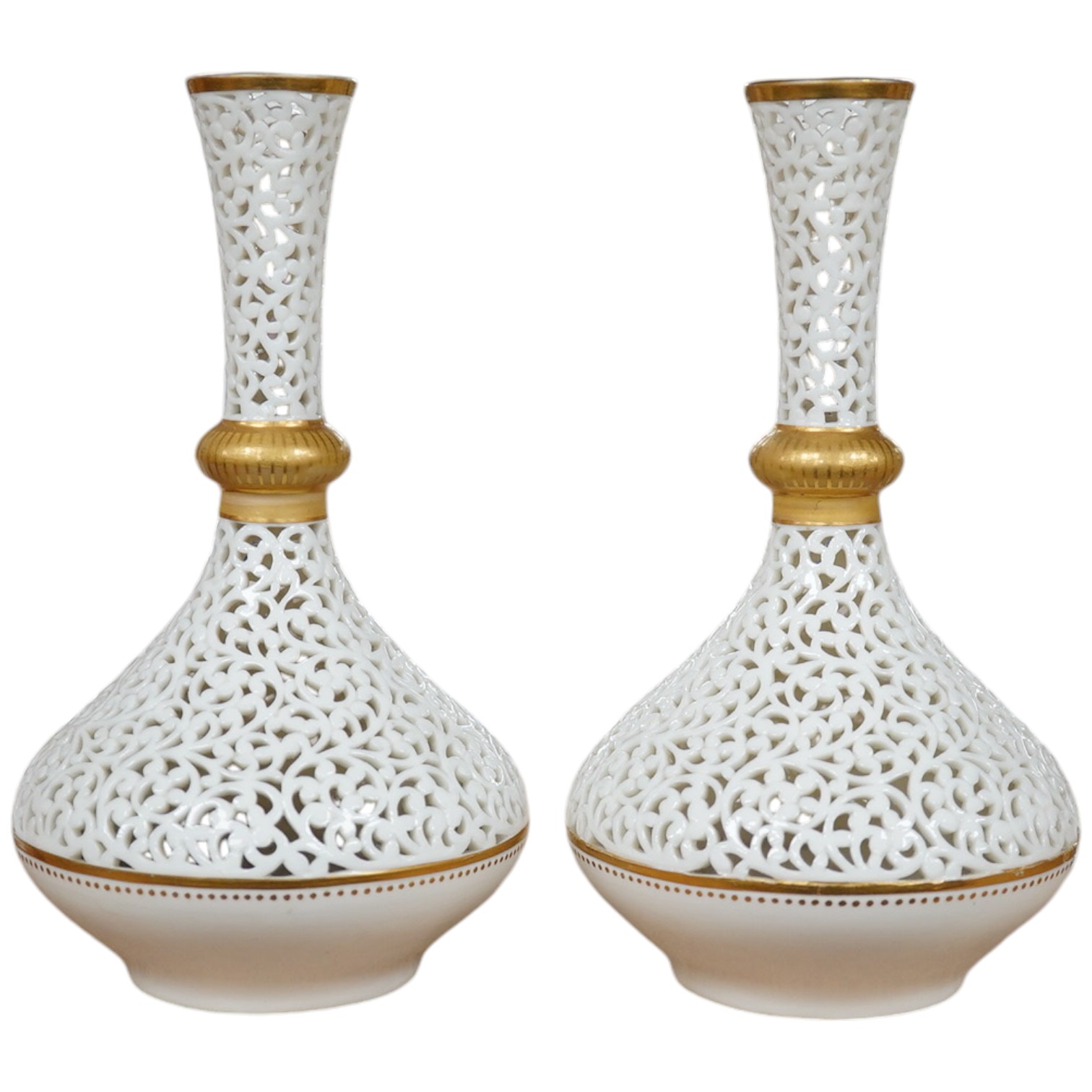 A pair of Grainger's reticulated vases with gilded decoration 16.5cm high. Condition - good